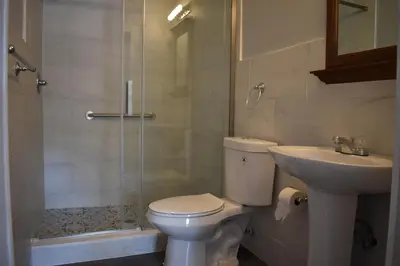 a bathroom with a toilet and a sink and a shower at Tannersville Village Room 1 in Tannersville