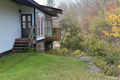 a small house with a porch and a deck at Tannersville Village Room 1 in Tannersville