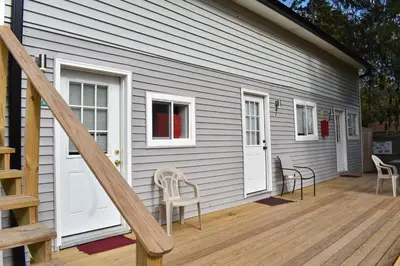 a house with a wooden deck with chairs on it at Tannersville Village Room 1 in Tannersville