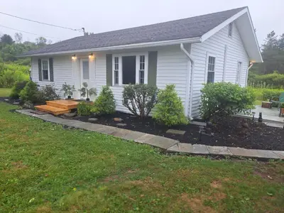 a house with a garden in front of it at Cozy Country Cottage in Norwich