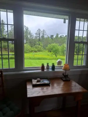 a window in a room with a wooden table in front of it at Cozy Country Cottage in Norwich