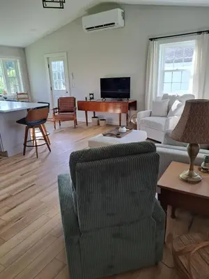 a living room with a couch and a piano at Cozy Country Cottage in Norwich