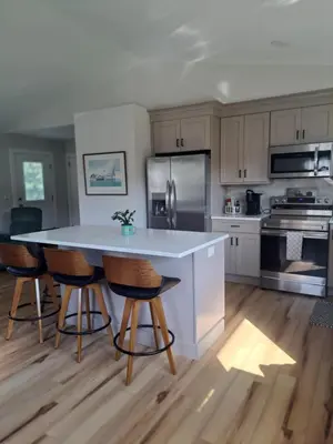 a kitchen with a table and some chairs in it at Cozy Country Cottage in Norwich