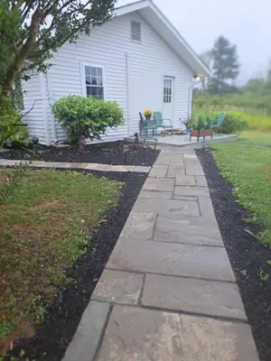 a stone walkway in front of a house at Cozy Country Cottage in Norwich