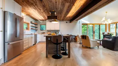 a kitchen with a wooden ceiling and a wooden table at Modern Catskills Escape w Open Living Steam Shower Hot Tub w Mountain Views Minutes from Woodstock Trails Suncliff Vista in Shokan
