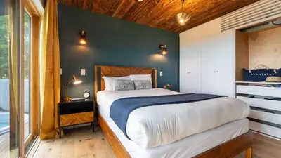 a bedroom with a bed and a green wall at Modern Catskills Escape w Open Living Steam Shower Hot Tub w Mountain Views Minutes from Woodstock Trails Suncliff Vista in Shokan