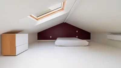 a attic bedroom with a bed and a skylight at Modern Catskills Escape w Open Living Steam Shower Hot Tub w Mountain Views Minutes from Woodstock Trails Suncliff Vista in Shokan