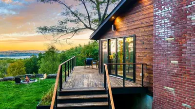 a wooden staircase leading to a house with a deck at Modern Catskills Escape w Open Living Steam Shower Hot Tub w Mountain Views Minutes from Woodstock Trails Suncliff Vista in Shokan