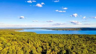 an aerial view of a lake in the woods at Modern Catskills Escape w Open Living Steam Shower Hot Tub w Mountain Views Minutes from Woodstock Trails Suncliff Vista in Shokan