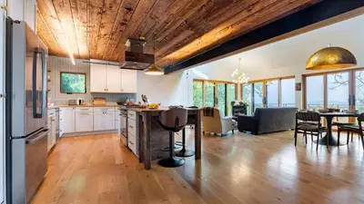an open kitchen and living room with a table and chairs at Modern Catskills Escape w Open Living Steam Shower Hot Tub w Mountain Views Minutes from Woodstock Trails Suncliff Vista in Shokan