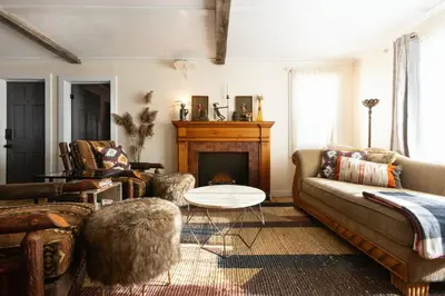 a living room with a couch and a fireplace at Cozy Cabin Style Apt Private 1st Flr 1 Bdrm in Torrington