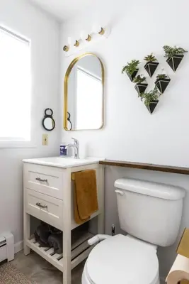a bathroom with a white toilet and a mirror at Private Classy 2nd Flr 3 Bed Apt Near Downtown in Torrington