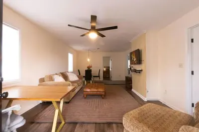 a living room with a couch and a ceiling fan at Private Classy 2nd Flr 3 Bed Apt Near Downtown in Torrington