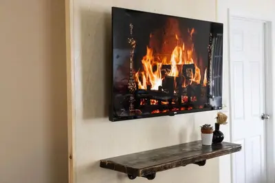 a fire in a fireplace on a wall at Private Classy 2nd Flr 3 Bed Apt Near Downtown in Torrington