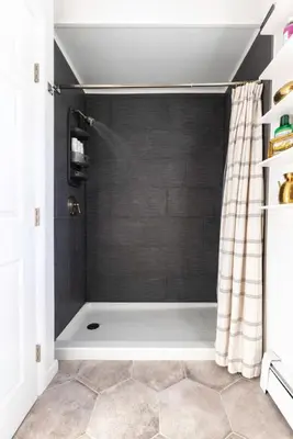 a bathroom with a shower with a shower curtain at Private Modern 1st Flr 3 Bed Apt Close to Downtown in Torrington