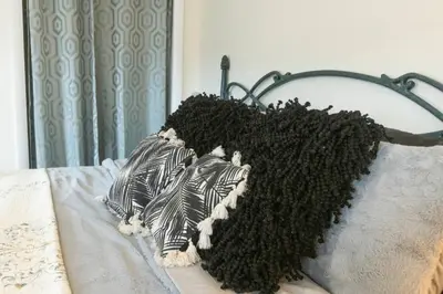 a black and white stuffed animal on a bed at Private Modern 1st Flr 3 Bed Apt Close to Downtown in Torrington