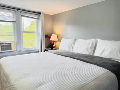 a bedroom with a large white bed with a window at Pocono Ridge Inn East Stroudsburg - Poconos in East Stroudsburg