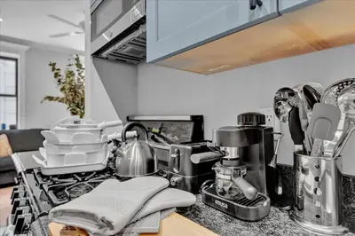 a kitchen counter top with a stove top oven at Stylish 3BR-2BA in Gramercy -Modern & Central in New York