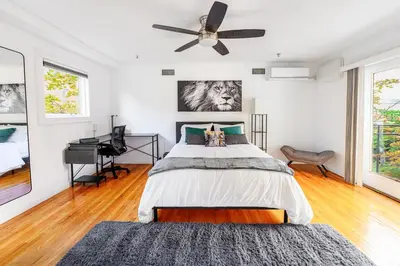 a bedroom with a bed and a ceiling fan at Modern 3BR Townhouse with Private Rooftop & Parking Minutes to NYC in Hoboken
