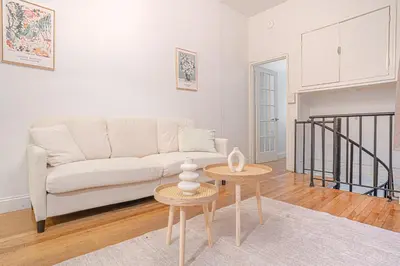 a living room with a couch and two tables at Charming Upper East Side W Outdoor Space in New York