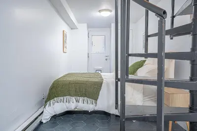 a bedroom with a bunk bed with a ladder at Charming Upper East Side W Outdoor Space in New York