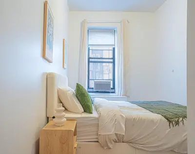 a bedroom with a bed and a window at Charming Upper East Side W Outdoor Space in New York
