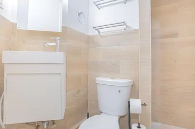 a bathroom with a white toilet and a sink at Charming Upper East Side W Outdoor Space in New York