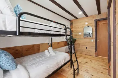 a bunk bed room with two bunk beds in a house at The birch House Heated Pool, Sauna, Hot Tub & More in Dover
