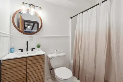 a bathroom with a toilet and a sink and a mirror at The birch House Heated Pool, Sauna, Hot Tub & More in Dover
