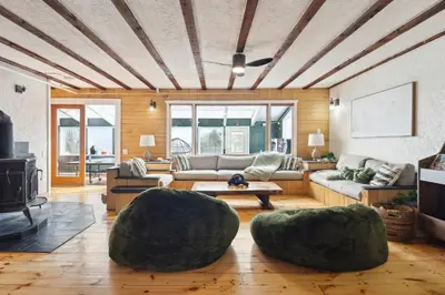 a living room with a couch and two large spheres at The birch House Heated Pool, Sauna, Hot Tub & More in Dover