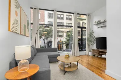 a living room with a couch and a table at Stylish Manhattan Escape in Prime Spot in New York