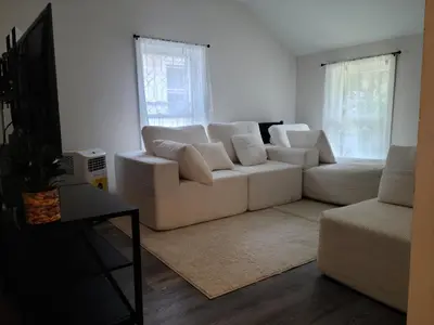 a living room with a white couch and a table at 3 bedrooms fully finished in Middletown