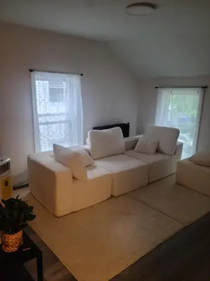 a living room with a white couch and windows at 3 bedrooms fully finished in Middletown