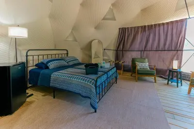a bedroom with a bed and a tv in it at Peaceful Dome Getaway in the Catskills in Gilboa