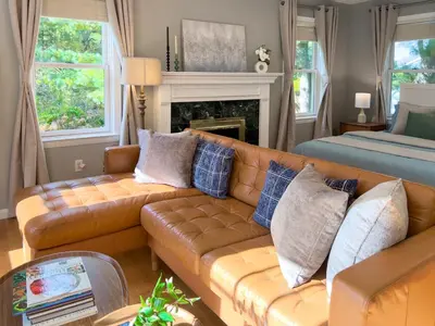 a living room with a couch and a bed at Serenity Haven - A Modern Retreat in Monroe
