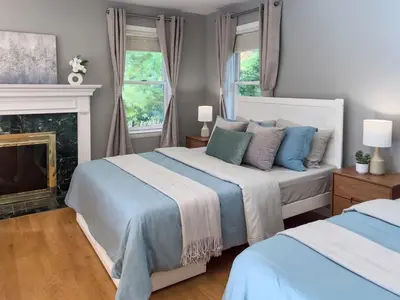 a bedroom with two beds and a fireplace at Serenity Haven - A Modern Retreat in Monroe
