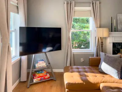 a living room with a couch and a flat screen tv at Serenity Haven - A Modern Retreat in Monroe