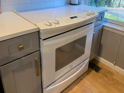 a kitchen with a white stove top oven in a kitchen at Serenity Haven - A Modern Retreat in Monroe