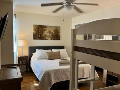a bedroom with a bed and a ceiling fan at NY-NJ Tennis Suites - Sleeps 40 - 15 Mins to NYC in Union City