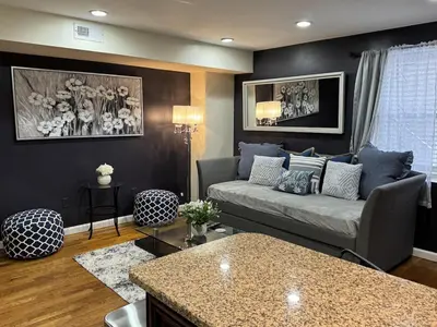 a living room with a couch and a table at NY-NJ Tennis Suites - Sleeps 40 - 15 Mins to NYC in Union City