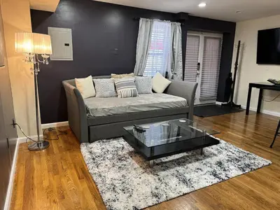 a living room with a couch and a coffee table at NY-NJ Tennis Suites - Sleeps 40 - 15 Mins to NYC in Union City
