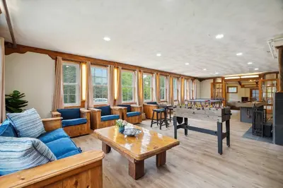 a living room with a couch and a ping pong table at Myrtle Villa 7BR Near Mount Snow with Indoor Heated Endless Style Pool Outdoor Hot Tub in Dover