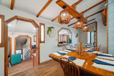 a dining room with a wooden table and chairs at Myrtle Villa 7BR Near Mount Snow with Indoor Heated Endless Style Pool Outdoor Hot Tub in Dover
