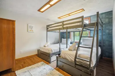 a bedroom with two bunk beds in it at Myrtle Villa 7BR Near Mount Snow with Indoor Heated Endless Style Pool Outdoor Hot Tub in Dover