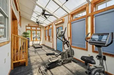 a gym with a treadmill and a bike in a room at Myrtle Villa 7BR Near Mount Snow with Indoor Heated Endless Style Pool Outdoor Hot Tub in Dover