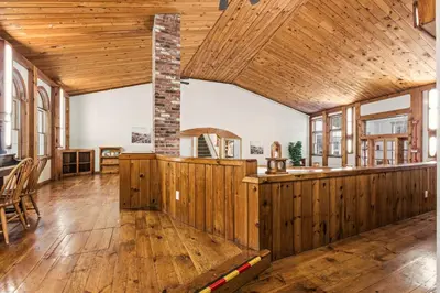 an open kitchen with wooden walls and a wooden ceiling at 12BR Villa Near Mount Snow Sleeps 32 Hot Tub & Indoor Pool in Dover