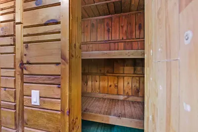 a wooden sauna with wooden walls and wooden floors at 12BR Villa Near Mount Snow Sleeps 32 Hot Tub & Indoor Pool in Dover