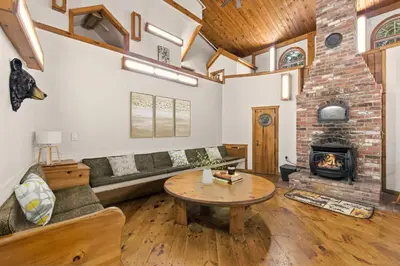 a living room with a couch and a fireplace at 12BR Villa Near Mount Snow Sleeps 32 Hot Tub & Indoor Pool in Dover