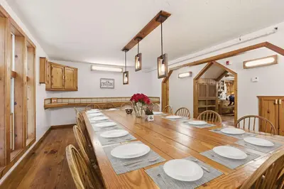 a dining room with a long table and chairs at 12BR Villa Near Mount Snow Sleeps 32 Hot Tub & Indoor Pool in Dover