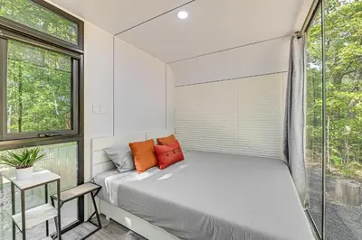a bedroom with a bed and a window at Waterfront Durham Getaway with Deck and Trails! in East Durham